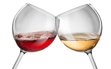 Moving red and white wine glass over a white background