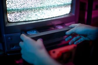 1667768247 Close up of hands insert vhs into old cathode screen
retrowave and aesthetic vibes