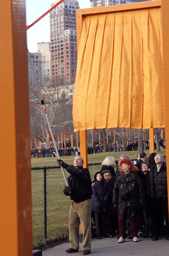 Mayor Michael Bloomberg unfurls "The Gates" by Christo and Jeanne Claude in Central Park in New York City on February 12, 2005. The 23-mile long pubic art installation was originally conceived over two decades ago.. (Photo by Shawn Ehlers/WireImage)