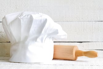 Chef hat and wooden kitchenware food abstract on white boards