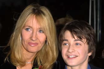 LONDON - NOVEMBER 4:  British author J.K. Rowling, creator of the Harry Potter children's books, and 11 year old Daniel Radcliffe (Harry Potter in the film version) attend the world film premiere of "Harry Potter and The Philosopher's Stone" at the Odeon Leicester Square cinema in London on November 4, 2001. The movie is titled "Harry Potter and The Sorcerer's Stone" for it's U.S. release. (Photo by Gareth Davies/Getty Images)