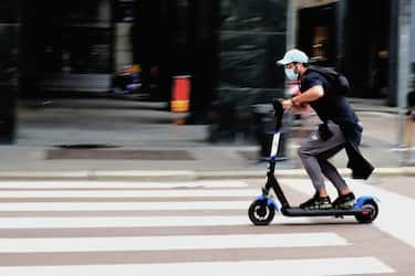 MILAN, ITALY - MAY 15:  A man wearing a protective mask rides a scooter on May 11, 2020 in Milan, Italy. Italy was the first country to impose a nationwide lockdown to stem the transmission of the Coronavirus (Covid-19), and its restaurants, theaters and many other businesses remain closed.  (Photo by Pier Marco Tacca/Getty Images)