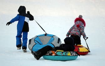 Children having fun on snow tubes. Kids is riding a tubing, winter entertainment