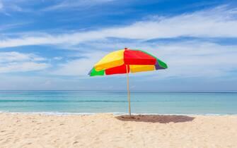 1288832157 Colorful umbrella and white sand beach in sunshine day at Patong Beach, Phuket Island, Thailand. Nature and travel concept
