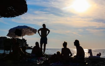People are resting on a beach in Primosten, Croatia on September 13, 2021. (Photo by Beata Zawrzel/NurPhoto)