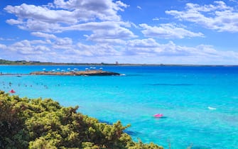 Punta della SPunta della Suina beach in Salento, Apulia. Italy. It's surrounded by the  Mediterranean scrub and by pine forest, boasts two small sandy bays and a small islet, which is almost separated by coast.uina, surrounded by the lush Mediterranean.