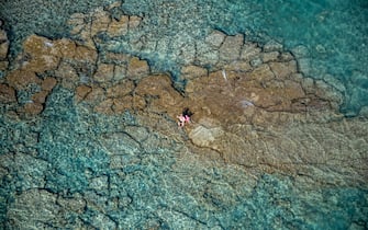 CASTIGLIONCELLO, ITALY - JUNE 29: Aerial view, from a helicopter, of a couple in the crystal clear waters of the Tuscan Maremma on June 29, 2019 in Castiglioncello, Italy. Italy's nearly 8000 km (5,000 miles) coastlines and islands stretch across the Mediterranean Sea and attract large numbers of both local and foreign tourists during the summer season. (Photo by Fabrizio Villa/Getty Images)