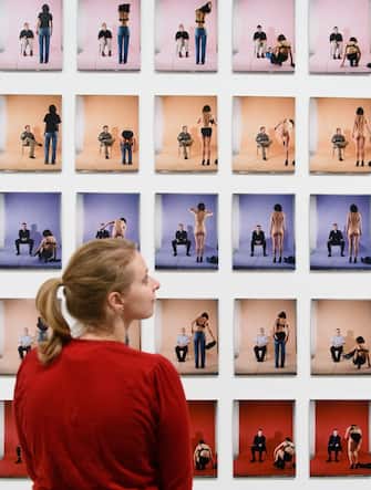 A woman poses for a photograph with artwork entitled "Strip" by British artist Jemima Stehli, displayed at the "Performing for the Camera" exhibition at the Tate Modern gallery in London on February 16, 2016.
The exhibition, said to examine the relationship between photography and performance, is set to run from February 18 - June 12, 2016. / AFP / LEON NEAL / RESTRICTED TO EDITORIAL USE - MANDATORY MENTION OF THE ARTIST UPON PUBLICATION - TO ILLUSTRATE THE EVENT AS SPECIFIED IN THE CAPTION        (Photo credit should read LEON NEAL/AFP via Getty Images)