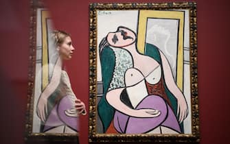 LONDON, ENGLAND - MARCH 06:  A woman poses in front of "Sleeping Woman by a Mirror" by Pablo Picasso at the Tate Modern on March 6, 2018 in London, England.  "Picasso 1932: Love, Fame and Tragedy" is the first solo exhibition at Tate Modern of the artist's work and includes more than 100 works.  (Photo by Leon Neal/Getty Images)