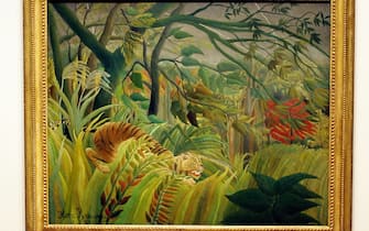 LONDON, United Kingdom:  CAPTION CORRECTION: A painting entitled "Tiger in a Tropical Storm (Surprised!)" painted by French artist Henri Rousseau is seen at the Tate Modern gallery in London 01 November 2005. An exhibition showing over fifty of Rousseau's painting's will go on display in London until February 2006. Rousseau  (1844-1910) became synonymous with paintings of jungle scenes despite never having left France. AFP PHOTO/CARL DE SOUZA  (Photo credit should read CARL DE SOUZA/AFP via Getty Images)