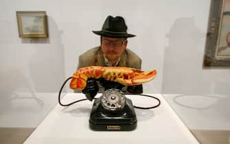 A man looks at a Salvador Dali sculpture entitled Lobster Telephone made in 1936 at the Tate Modern art gallery, London, 30 May 2007. Tate Modern are displaying a range of works of art by Salvador Dali including films sculptures and paintings. AFP PHOTO/CARL DE SOUZA.        (Photo credit should read CARL DE SOUZA/AFP via Getty Images)