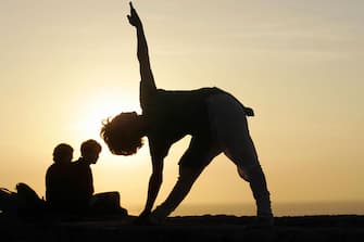 A Moroccan woman performs yoga exercises in Rabat, 25 September 2007. AFP PHOTO/ABDELHAK SENNA (Photo credit should read ABDELHAK SENNA/AFP via Getty Images)