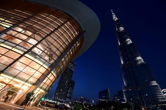 TOPSHOT - A picture taken on June 6, 2017 shows a general view of the exterior of the Dubai Opera with the Burj Khalifa nearby, in downtown Dubai in the United Arab Emirates. / AFP PHOTO / GIUSEPPE CACACE        (Photo credit should read GIUSEPPE CACACE/AFP via Getty Images)