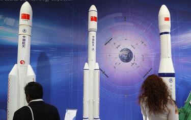 epa07061162 Visitors looks at scale models of (L-R) type LM5, LM7 and LM6 rockets at the booth of the China Aerospace Science and Technology Corporation at the International Astronautical Congress IAC in Bremen, northern Germany, 01 October 2018. More than 6,000 scientists and space experts meet for the 69th edition of one of the world's biggest space-related congresses which runs until 05 October.  EPA/FOCKE STRANGMANN