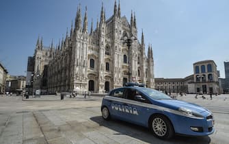 A police car outside the Milan cathedral where a man attacked a security guard with a knife before being arrested,  Italy, 12 August 2020. ANSA / MATTEO CORNER