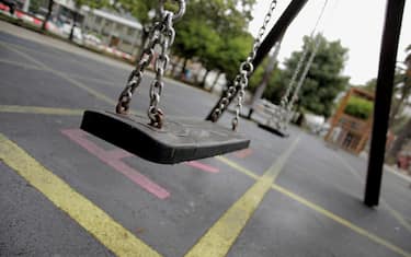 epa08486500 Swings are seen at a playground in A Coruna, Galicia, Spain, where children are finally allowed to use them as the region reaches the 'new normality', 15 June 2020. Galicia is Spain's first region that leaves behind the alarm status to start the so called 'new normality' in which face masks are obligatory in public spaces and common spaces such as playgrounds have a new capacity with a less amount of people to avoid crowded areas.  EPA/Cabalar
