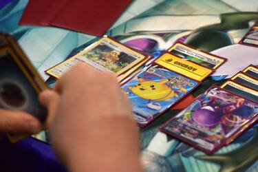 LONDON, ENGLAND - AUGUST 18: A competitor holds a deck containing a Flying Pikachu Vmax card while playing Pokemon cards during the 2022 Pokémon World Championships at ExCel on August 18, 2022 in London, England. For the first time in history, the championship event is being held outside of North America, London Excel will host the competition on August 18â 21. Some of the best Pokémon players from around the will compete in Pokémon TCG, the Pokémon Sword and Pokémon Shield video games, Pokémon GO, Pokémon UNITE, and Pokkén Tournament DX. Half a million dollars in prizes, the title of Pokémon World Champion, and return invitations for the following year's Worlds are up for grabs. (Photo by John Keeble/Getty Images)