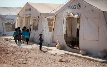Displaced Syrian children attend a school housed under two UNICEF tents at a camp near al-Dana town in northwestern Syria on September 10, 2019. - Years of fighting and displacement in Idlib province have wrought chaos for the education of children, destroying schools and scattering families into homelessness across the countryside. (Photo by Aaref WATAD / AFP)        (Photo credit should read AAREF WATAD/AFP via Getty Images)