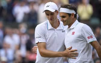 Hubert Hurkacz talks to Roger Federer after defeating him in the quarter-final of the Gentlemen's Singles on Centre Court on day nine of Wimbledon at The All England Lawn Tennis and Croquet Club, Wimbledon. Picture date: Wednesday July 7, 2021.
