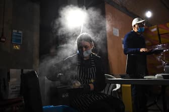 LONDON, ENGLAND - MAY 05: Volunteers wearing masks are seen putting together meals in a kitchen in an underground carpark run by the Hare Krishna on May 5, 2020 in London, England. The Hare Krishna are preparing and distributing meals to vulnerable people and communities across London in light of the Coronavirus pandemic. The country continues quarantine measures intended to curb the spread of Covid-19, but the infection rate is falling, and government officials are discussing the terms under which it would ease the lockdown. (Photo by Peter Summers/Getty Images)