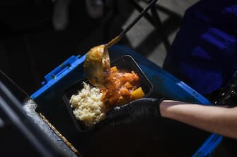LONDON, ENGLAND - MAY 05: A volunteer wearing gloves is seen putting together meals in a kitchen in an underground carpark run by the Hare Krishna on May 5, 2020 in London, England. The Hare Krishna are preparing and distributing meals to vulnerable people and communities across London in light of the Coronavirus pandemic. The country continues quarantine measures intended to curb the spread of Covid-19, but the infection rate is falling, and government officials are discussing the terms under which it would ease the lockdown. (Photo by Peter Summers/Getty Images)