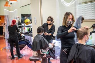 BERLIN, GERMANY - MAY 04: Hairdressers work at a hair salon that opened today for the first time since March during the novel coronavirus (Covid-19) crisis on May 4, 2020 in Berlin, Germany. Barber shops and hair salons are reopening this week nationwide as authorities carefully lift lockdown measures that had been imposed to stem the spread of the virus. (Photo by Maja Hitij/Getty Images)