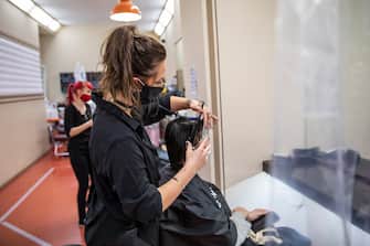 BERLIN, GERMANY - MAY 04: A hairdresser cuts customer hair at a hair salon that opened today for the first time since March during the novel coronavirus (Covid-19) crisis on May 4, 2020 in Berlin, Germany. Barber shops and hair salons are reopening this week nationwide as authorities carefully lift lockdown measures that had been imposed to stem the spread of the virus. (Photo by Maja Hitij/Getty Images)