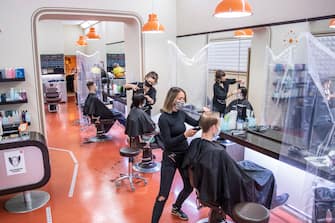 BERLIN, GERMANY - MAY 04: Hairdressers work at a hair salon that opened today for the first time since March during the novel coronavirus (Covid-19) crisis on May 4, 2020 in Berlin, Germany. Barber shops and hair salons are reopening this week nationwide as authorities carefully lift lockdown measures that had been imposed to stem the spread of the virus. (Photo by Maja Hitij/Getty Images)