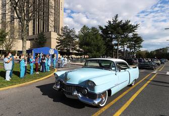EAST MEADOW, NEW YORK - MAY 04:  A parade of classic cars makes its way by Nassau University Medical Center to salute the healthcare workers on the front lines of the COVID-19 pandemic on May 04, 2020 in East Meadow, New York. (Photo by Al Bello/Getty Images)