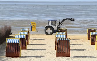 CUXHAVEN, GERMANY - MAY 06: A tractor moves beach chairs stand ready for vacationers at Duhne beach during the coronavirus crisis on May 6, 2020 near Cuxhaven, Germany. German states that contain popular holiday destinations and that are economically dependant on tourism, including Lower Saxony, Mecklenburg-Western Pomerania, Schleswig-Holstein and Bavaria, have announced an easing of lockdown measures in order to let hotels, restaurants and beaches reopen for visitors in coming weeks. (Photo by Stuart Franklin/Getty Images)
