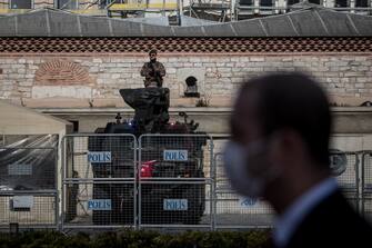 1220638290 ISTANBUL, TURKEY - APRIL 23: A Turkish Special Forces soldier stands guard at Taksim Square on the National Sovereignty and Childrenâ s Day holiday on the first day of a four-day lockdown due to the ongoing coronavirus pandemic on April 23, 2020 in Istanbul, Turkey. During normal celebrations people attend memorial services, concerts, street parades, school activities and cultural events. However, this year due to the spread of the COVID-19 virus and an enforced lockdown many districts cancelled events and organized buses with bands playing live on the rooftop or vans playing music to tour neighborhoods to celebrate the holiday. As of April 23, according to the Health Ministry, Turkey has 2,491 Coronavirus related deaths and confirmed cases have risen to 101,790. Despite the rising numbers Turkey has avoided a full lockdown and continues to implement short lockdowns and constant revisions of current restrictions. The interior ministry has extended restrictions on travel between 31 cities for another 15 days, a curfew continues to be in place for anyone over the age of 65 and under 20, schools, cafes, bars and non-essential businesses remain closed. (Photo by Chris McGrath/Getty Images)