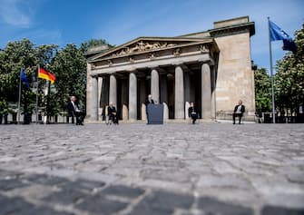 BERLIN, GERMANY - MAY 08: German Chancellor Angela Merkel (2nd-R), President of the German Parliament Bundestag Wolfgang Schaeuble (2nd -L), German President Frank-Walter Steinmeier (C), President of the Federal Council Bundesrat in Germany Dietmar Woidke (L)  and the presiding judge of the German Federal Constitutional Court's second senate, Andreas Vosskuhle (R) attend a ceremony to mark the 75th anniversary of the end of World War Two, at the Neue Wache Memorial on May 8, 2020 in Berlin, Germany. (Photo by Filip Singer - Pool/Getty Images)