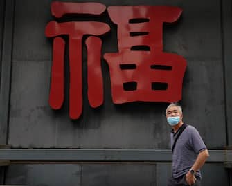 BEIJING, CHINA - MAY 08:  A Chinese man wears a protective mask as he looks on May 8, 2020 in Beijing, China. Life in Beijing is slowly returning to normal following a city-wide lockdown on January 25 to contain the coronavirus (COVID-19) outbreak. (Photo by Lintao Zhang/Getty Images)