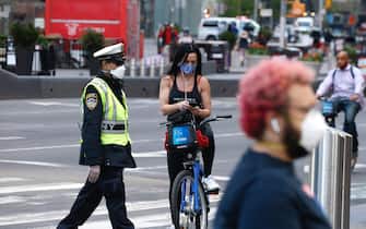 1223542904 NEW YORK, NEW YORK - MAY 07: New Yorkers wearing protective masks are seen in Times Square as daily life continues amid the coronavirus outbreak on May 07, 2020 in New York City. COVID-19 has spread to most countries around the world, claiming over 270,000 lives and infecting over 3.9 million people. (Photo by John Lamparski/Getty Images)