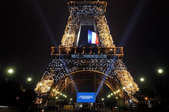 PARIS, FRANCE - MAY 10: A large screen in front of the Eiffel Tower displays photos of Parisians, caregivers and medical personnel to thank them for their dedication during the coronavirus pandemic on May 10, 2020 in Paris, France. The French government has drawn up a deconfinement plan that will take effect on May 11. The Coronavirus (COVID-19) pandemic has spread to many countries across the world, claiming over 280,000 lives and infecting over 4 million people. (Photo by Chesnot/Getty Images)