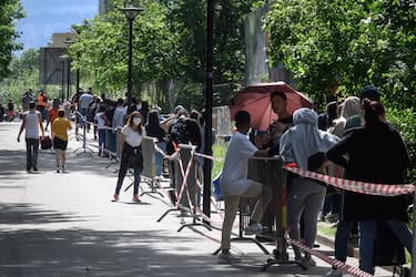 People in need queue at a free food distribution on May 9, 2020 in Geneva as the COVID-19 pandemic casts a spotlight on the usually invisible poor people of Geneva, one of the world's most expensive cities. (Photo by Fabrice COFFRINI / AFP) (Photo by FABRICE COFFRINI/AFP via Getty Images)