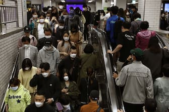 SEOUL, SOUTH KOREA - MAY 11: South Korean commuters wear protective masks as they crowd on an escalator and stairs after getting off the subway during rush hour on May 11, 2020 in Seoul, South Korea. Coronavirus cases linked to clubs and bars in Seoul's multicultural district of Itaewon have jumped to 54, an official said Sunday, as South Korea struggles to stop the cluster infection from spreading further. According to the Korea Center for Disease Control and Prevention, 35 new cases were reported. The total number of infections in the nation tallies at 10,909. (Photo by Chung Sung-Jun/Getty Images)