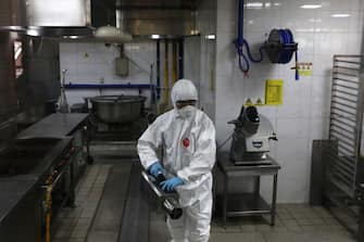 1224086919 SEOUL, SOUTH KOREA - MAY 11: A disinfection professional wearing protective clothing spray anti-septic solution at cafeteria to prevent the spread of the coronavirus (COVID-19) ahead of school re-opening on May 11, 2020 in Seoul, South Korea. South Korea's education ministry announced plans to re-open schools starting from May 13, more than two months after schools were closed in a precautionary measure against the coronavirus. Coronavirus cases linked to clubs and bars in Seoul's multicultural district of Itaewon have jumped to 54, an official said Sunday, as South Korea struggles to stop the cluster infection from spreading further. According to the Korea Center for Disease Control and Prevention, 35 new cases were reported. The total number of infections in the nation tallies at 10,909. (Photo by Chung Sung-Jun/Getty Images)