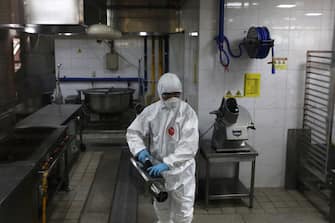 SEOUL, SOUTH KOREA - MAY 11: A disinfection professional wearing protective clothing spray anti-septic solution at cafeteria to prevent the spread of the coronavirus (COVID-19) ahead of school re-opening on May 11, 2020 in Seoul, South Korea. South Korea's education ministry announced plans to re-open schools starting from May 13, more than two months after schools were closed in a precautionary measure against the coronavirus. Coronavirus cases linked to clubs and bars in Seoul's multicultural district of Itaewon have jumped to 54, an official said Sunday, as South Korea struggles to stop the cluster infection from spreading further. According to the Korea Center for Disease Control and Prevention, 35 new cases were reported. The total number of infections in the nation tallies at 10,909. (Photo by Chung Sung-Jun/Getty Images)