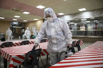 SEOUL, SOUTH KOREA - MAY 11: Disinfection professionals wearing protective clothing spray anti-septic solution at cafeteria to prevent the spread of the coronavirus (COVID-19) ahead of school re-opening on May 11, 2020 in Seoul, South Korea. South Korea's education ministry announced plans to re-open schools starting from May 13, more than two months after schools were closed in a precautionary measure against the coronavirus. Coronavirus cases linked to clubs and bars in Seoul's multicultural district of Itaewon have jumped to 54, an official said Sunday, as South Korea struggles to stop the cluster infection from spreading further. According to the Korea Center for Disease Control and Prevention, 35 new cases were reported. The total number of infections in the nation tallies at 10,909. (Photo by Chung Sung-Jun/Getty Images)