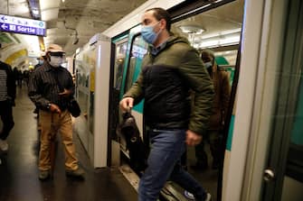 Commuters wearing face masks are seen at a metro station, on May 11, 2020 in Paris, as the lockdown introduced two months ago to fight the spread of the Covid-19 disease caused by the novel coronavirus starts to ease. (Photo by GEOFFROY VAN DER HASSELT / AFP) (Photo by GEOFFROY VAN DER HASSELT/AFP via Getty Images)