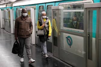 Commuters wearing face masks are seen at a metro station, on May 11, 2020 in Paris, as the lockdown introduced two months ago to fight the spread of the Covid-19 disease caused by the novel coronavirus starts to ease. (Photo by GEOFFROY VAN DER HASSELT / AFP) (Photo by GEOFFROY VAN DER HASSELT/AFP via Getty Images)