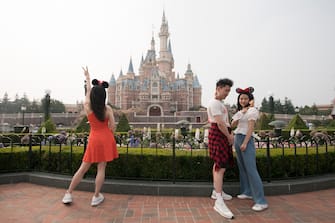 SHANGHAI, CHINA - MAY 11: Tourists visit Shanghai Disneyland after its reopening on May 11, 2020 in Shanghai, China. Shanghai Disneyland has reopened its gates following months of shutdown, offering a potential model for other mass entertainment venues around the world to open for business during the pandemic. (Photo by Hu Chengwei/Getty Images)