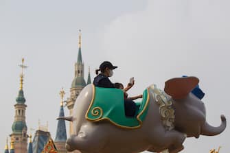 SHANGHAI, CHINA - MAY 11: Tourists visit Shanghai Disneyland after its reopening on May 11, 2020 in Shanghai, China. Shanghai Disneyland has reopened its gates following months of shutdown, offering a potential model for other mass entertainment venues around the world to open for business during the pandemic. (Photo by Hu Chengwei/Getty Images)