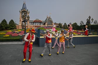 Musicians perform during the reopening of the Disneyland amusement park in Shanghai on May 11, 2020. - Disneyland Shanghai reopened on May 11 to the public after being closed since January due to the COVID-19 coronavirus outbreak. (Photo by Hector RETAMAL / AFP) (Photo by HECTOR RETAMAL/AFP via Getty Images)