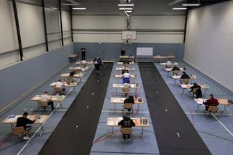 epa08416458 Students write their final examination paper on biology, in a sports hall, which has been converted into a classroom in accordance with the latest German health regulations, at the Privat High School Stadtkrone (PGS) in Dortmund, Germany, 12 May 2020. Due to the ongoing coronavirus pandemic, the final secondary-school examinations in the German state of North Rhine-Westphalia are starting with strict safety precautions.  EPA/FRIEDEMANN VOGEL