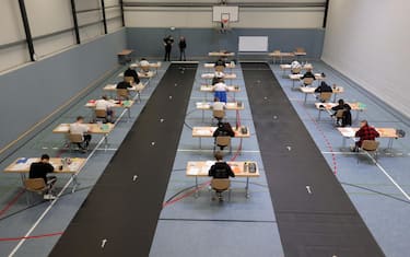 epa08416460 Students write their final examination paper on biology, in a sports hall, which has been converted into a classroom in accordance with the latest German health regulations, at the Privat High School Stadtkrone (PGS) in Dortmund, Germany, 12 May 2020. Due to the ongoing coronavirus pandemic, the final secondary-school examinations in the German state of North Rhine-Westphalia are starting with strict safety precautions. EPA/FRIEDEMANN VOGEL