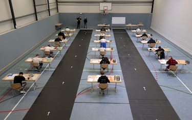 epa08416460 Students write their final examination paper on biology, in a sports hall, which has been converted into a classroom in accordance with the latest German health regulations, at the Privat High School Stadtkrone (PGS) in Dortmund, Germany, 12 May 2020. Due to the ongoing coronavirus pandemic, the final secondary-school examinations in the German state of North Rhine-Westphalia are starting with strict safety precautions.  EPA/FRIEDEMANN VOGEL