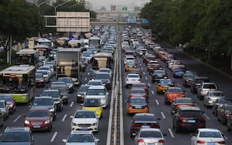 Cars are seen on a road in Beijing on May 12, 2020. - Auto sales in China, which experienced a record low due to the coronavirus outbreak, are recovering as some Chinese seek an alternative to public transportation, but the upturn remains fragile. (Photo by GREG BAKER / AFP) (Photo by GREG BAKER/AFP via Getty Images)