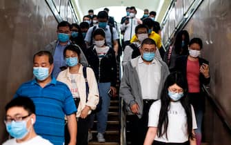 People wearing face masks amid concerns of the COVID-19 coronavirus commute through a subway station in Beijing on May 13, 2020. (Photo by NOEL CELIS / AFP) (Photo by NOEL CELIS/AFP via Getty Images)